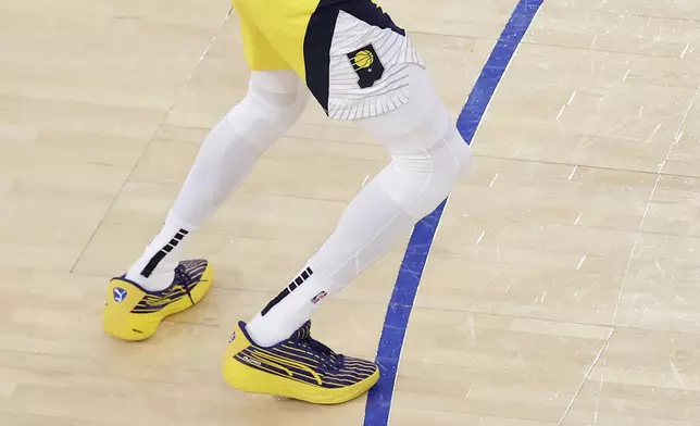 Indiana Pacers guard Tyrese Haliburton (0) steps on the 3-point line as he shoots a 2-point shot against the New York Knicks to tie the score at the end of regulation in Game 1 of the NBA basketball Eastern Conference final, Wednesday, May 21, 2025, in New York. (AP Photo/Adam Hunger)