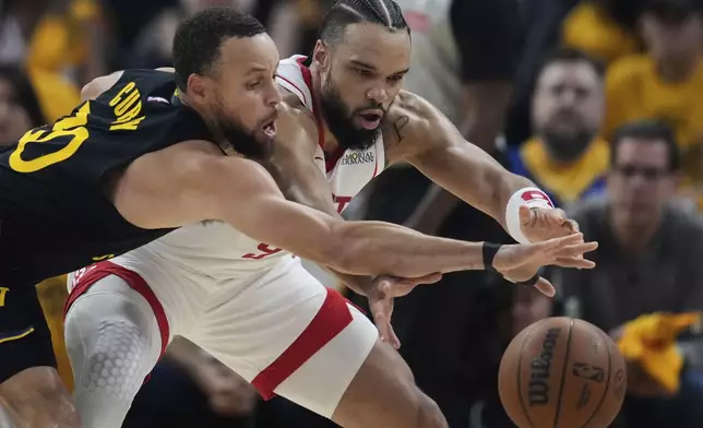 Golden State Warriors guard Stephen Curry, left, takes the ball away from Houston Rockets forward Dillon Brooks during the first half of Game 6 of an NBA basketball first-round playoff series Friday, May 2, 2025, in San Francisco. (AP Photo/Godofredo A. Vásquez)