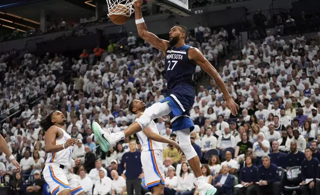 Minnesota Timberwolves center Rudy Gobert (27) dunks against the Oklahoma City Thunder during the second half of Game 3 of the Western Conference finals of the NBA basketball playoffs, Saturday, May 24, 2025, in Minneapolis. (AP Photo/Abbie Parr)