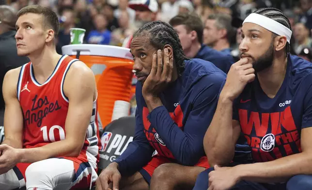 From left to right, Los Angeles Clippers guard Bogdan Bogdanovic, forward Kawhi Leonard and guard Ben Simmons look on as time runs out in Game 7 of an NBA basketball first-round playoff series against the Denver Nuggets,Saturday, May 3, 2025, in Denver. (AP Photo/David Zalubowski)