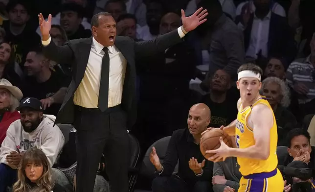Minnesota Timberwolves co-owner Alex Rodriguez, left, questions a non call as Los Angeles Lakers guard Austin Reaves looks on during the second half in Game 5 of an NBA basketball first-round playoff series Wednesday, April 30, 2025, in Los Angeles. (AP Photo/Mark J. Terrill)