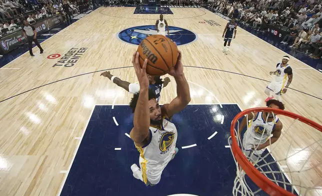 Golden State Warriors forward Trayce Jackson-Davis (32) goes up for a dunk as Minnesota Timberwolves center Naz Reid (11), back, defends during the second half of Game 2 of an NBA basketball second-round playoff series, Thursday, May 8, 2025, in Minneapolis. (AP Photo/Abbie Parr)