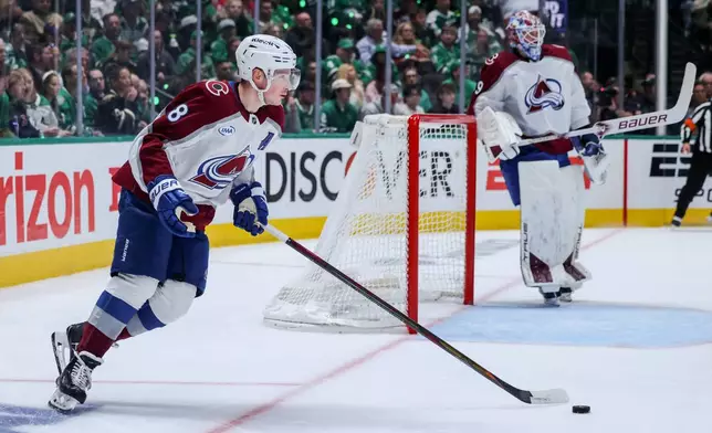 Colorado Avalanche defenseman Cale Makar (8) controls the puck during the first period of Game 5 of a first-round NHL hockey playoff series against the Dallas Stars in Dallas, Monday, April 28, 2025. (AP Photo/Gareth Patterson)
