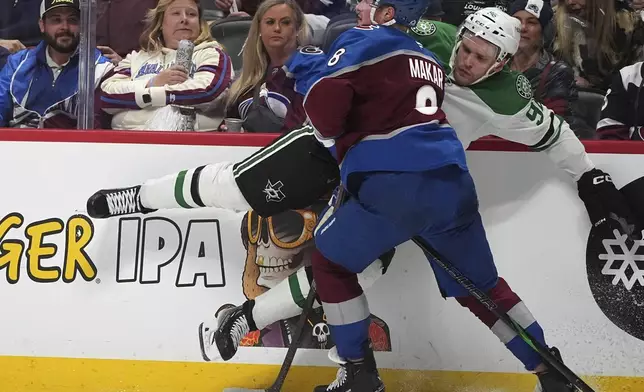 Colorado Avalanche defenseman Cale Makar, front, checks Dallas Stars right wing Mikko Rantanen, back, in the second period of Game 6 of an NHL hockey first-round playoff series Thursday, May 1, 2025, in Denver. (AP Photo/David Zalubowski)