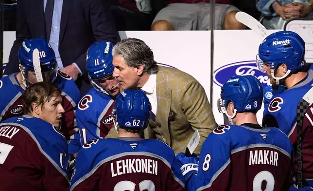 Colorado Avalanche head coach Jared Bednar, back center, talks to players during a time out in the third period of Game 6 of an NHL first-round hockey playoff series against the Dallas Stars, Thursday, May 1, 2025, in Denver. (AP Photo/David Zalubowski)