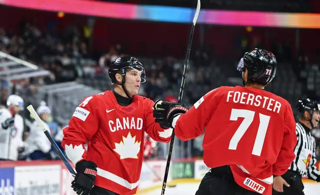 Canada's scorer Bo Horvat, left, celebrates 1-0 with Tyson Foerster during the IIHF Ice Hockey World Championship group A match between Canada and France at Avicii Arena in Stockholm, Sweden, Tuesday May 13, 2025. (Anders Wiklund/TT News Agency via AP)