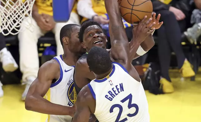Minnesota Timberwolves' Anthony Edwards tries to score between Golden State Warriors' Draymond Green and Jonathan Kuminga in 2nd quarter during NBA Western Conference Semifinals' Game 3 at Chase Center in San Francisco on Saturday, May 10, 2025. (Scott Strazzante/San Francisco Chronicle via AP)