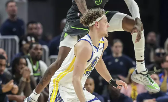 Jaden McDaniels (3) of Minnesota Timberwolves leaps to defend againt Brandin Podziemski (2) of the Golden State Warriors in the first half in Game 3 of the Conference Semifinals of the NBA Playoffs at Chase Center in San Francisco., on Saturday, May 10, 2025.(Carlos Avila Gonzalez/San Francisco Chronicle via AP)