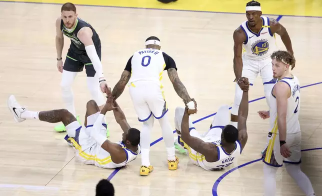 Golden State Warriors' Draymond Green and Jonathan Kuminga are helped up by Gary Payton II, Jimmy Butler III and Minnesota Timberwolves' Donte Divincenzo in 1st quarter during NBA Western Conference Semifinals' Game 3 at Chase Center in San Francisco on Saturday, May 10, 2025. (Scott Strazzante/San Francisco Chronicle via AP)