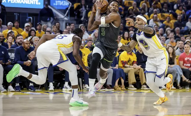 Anthony Edwards (5) of Minnesota Timberwolves drives to the basket between Gary Payton II (0) and Draymond Green (23) of Golden State Warriors in the first half of Game 3 of the Conference Semifinals of the NBA Playoffs at Chase Center in San Francisco., on Saturday, May 10, 2025. (Carlos Avila Gonzalez/San Francisco Chronicle via AP)