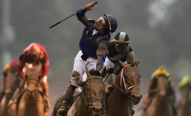 Jockey Junior Alvarado celebrates after riding Sovereignty to victory in the 151st running of the Kentucky Derby horse race at Churchill Downs Saturday, May 3, 2025, in Louisville, Ky. (AP Photo/Brynn Anderson)