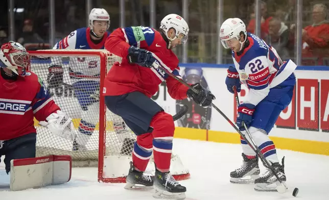 USA's Isaac Howard, right, and Norway's Markus Vikingstad, second right, challenge for the puck during the group B match between USA and Norway at the IIHF Ice Hockey World Championships in Herning, Denmark, Wednesday, May 14, 2025. (Bo Amstrup/Ritzau Scanpix via AP)