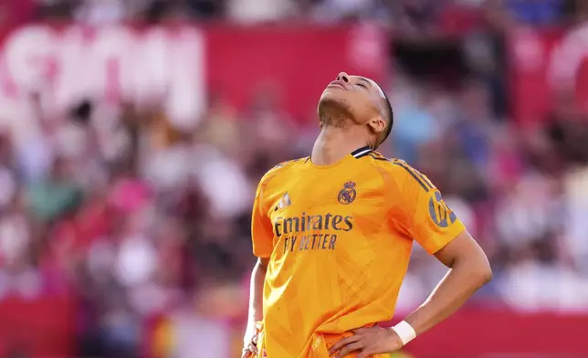 Real Madrid's Kylian Mbappe reacts during the Spanish La Liga soccer match between Sevilla and Real Madrid at the Ramon Sanchez Pizjuan stadium in Seville, Spain, Sunday, May 18, 2025. (AP Photo/Jose Breton)