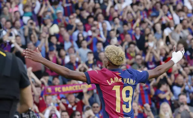 Barcelona's Lamine Yamal celebrates after scoring his side's first goal during the Spanish La Liga soccer match between Barcelona and Villarreal at Lluis Companys Olympic Stadium in Barcelona, Spain, Sunday, May 18, 2025. (AP Photo/Joan Monfort)
