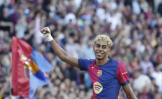 Barcelona's Lamine Yamal celebrates after scoring his side's first goal during the Spanish La Liga soccer match between Barcelona and Villarreal at Lluis Companys Olympic Stadium in Barcelona, Spain, Sunday, May 18, 2025. (AP Photo/Joan Monfort)