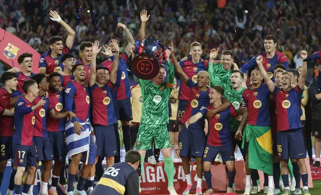 Barcelona's team members celebrate winning the La Liga after the Spanish La Liga soccer match between Barcelona and Villarreal at Lluis Companys Olympic Stadium in Barcelona, Spain, Sunday, May 18, 2025. (AP Photo/Joan Monfort)