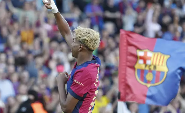 Barcelona's Lamine Yamal celebrates after scoring his side's first goal during the Spanish La Liga soccer match between Barcelona and Villarreal at Lluis Companys Olympic Stadium in Barcelona, Spain, Sunday, May 18, 2025. (AP Photo/Joan Monfort)