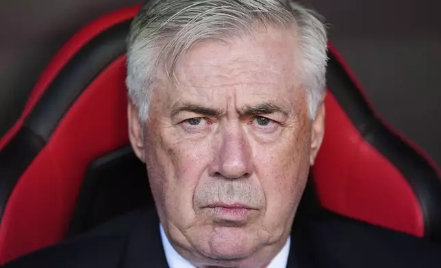 Real Madrid's head coach Carlo Ancelotti waits for the start of a Spanish La Liga soccer match between Sevilla and Real Madrid at the Ramon Sanchez Pizjuan stadium in Seville, Spain, Sunday, May 18, 2025. (AP Photo/Jose Breton)