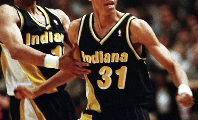 FILE - Indiana Pacers guards Reggie Miller (31) and Mark Jackson taunt New York film director and avid Knicks fan Spike Lee, after Miller scored eight points in the last quarter of the game against the Knicks, at New York's Madison Square Garden, May 7, 1995. (AP Photo/Bill Kostroun, File)