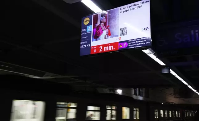 A screen at the subway displays a picture of newly elected Pope Leo XIV in Buenos Aires, Argentina, Thursday, May 8, 2025. (AP Photo/Natacha Pisarenko)