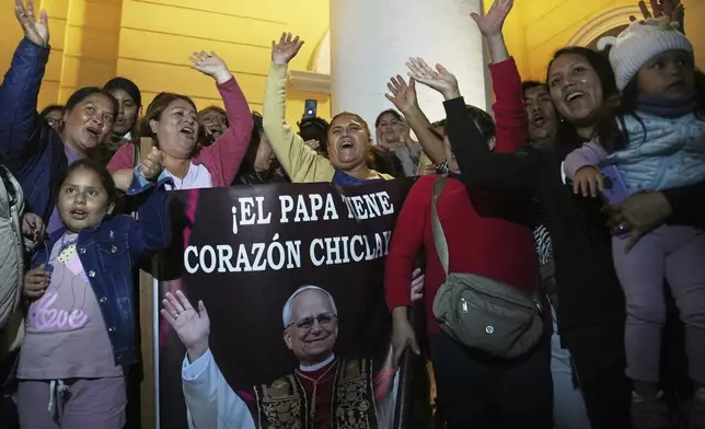 Parishioners hold a photo of Bishop Robert Prevost, elected Pope Leo XIV, after Mass at the Cathedral of Chiclayo, Peru, where he served as bishop for several years, Thursday, May 8, 2025. (AP Photo/Guadalupe Pardo)