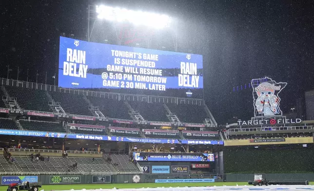 The scoreboard announces the suspension of a baseball game during the fourth inning between the Minnesota Twins and the Cleveland Guardians, Monday, May 19, 2025, in Minneapolis. (AP Photo/Matt Krohn)