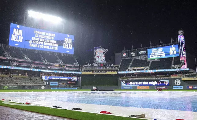 The scoreboard announces the suspension of a baseball game during the fourth inning between the Minnesota Twins and the Cleveland Guardians, Monday, May 19, 2025, in Minneapolis. (AP Photo/Matt Krohn)