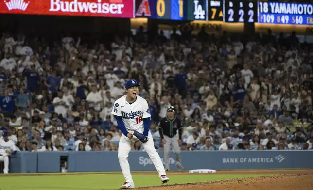 Los Angeles Dodgers starting pitcher Yoshinobu Yamamoto reacts after striking out Arizona Diamondbacks' Pavin Smith during the seventh inning of a baseball game in Los Angeles, Tuesday, May 20, 2025. (AP Photo/Kyusung Gong)