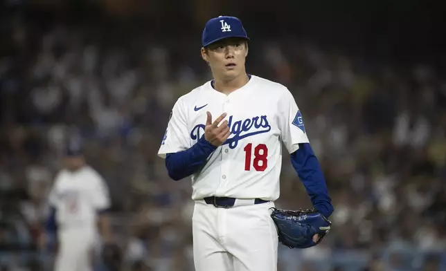 Los Angeles Dodgers starting pitcher Yoshinobu Yamamoto gestures during the seventh inning of a baseball game against the Arizona Diamondbacks in Los Angeles, Tuesday, May 20, 2025. (AP Photo/Kyusung Gong)