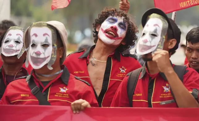 A laborer with their face painted as the Joker chants slogans during a May Day rally in Jakarta, Indonesia, Thursday, May 1, 2025. (AP Photo/Tatan Syuflana)