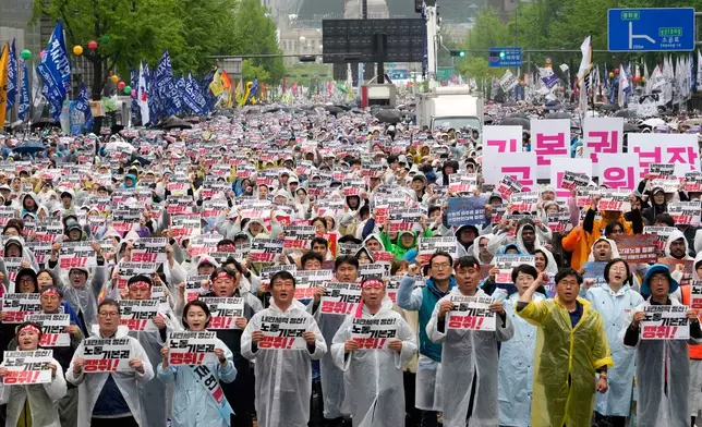 Members of the Korean Confederation of Trade Unions gather to attend a rally on May Day in Seoul, South Korea, Thursday, May 1, 2025. The letters read "Let's win basic labor rights." (AP Photo/Ahn Young-joon)