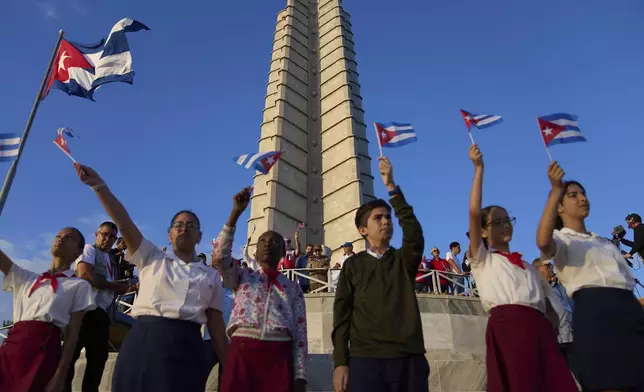Raul Castro watches the May Day parade from the base of the José Martí Memorial tower, as students wave national flags at Revolution Square in Havana, Thursday, May 1, 2025. (AP Photo/Ramon Espinosa)