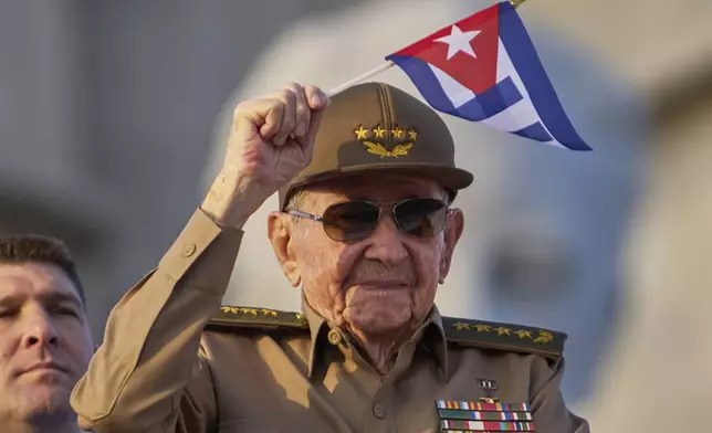 Raul Castro waves a Cuban national flag while attending the May Day parade at Revolution Square in Havana, Thursday, May 1, 2025. (AP Photo/Ramon Espinosa)