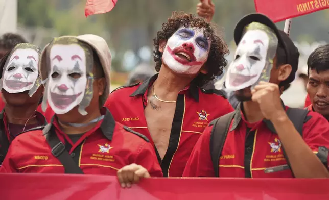 A laborer with the face painted as the Joker chants slogans during a May Day rally in Jakarta, Indonesia Thursday, May 1, 2025. (AP Photo/Tatan Syuflana)