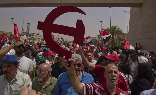 Supporters of the Iraqi Communist Party they take part in the May Day celebration in Baghdad, Iraq, Thursday, May 1, 2025. (AP Photo/Hadi Mizban)