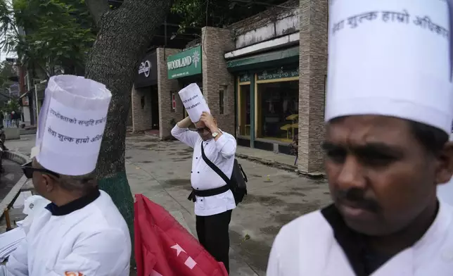 Workers affiliated with Communist Party of Nepal (Maoist Centre) get ready to participate in a May Day rally in Kathmandu, Nepal, Thursday, May 1, 2025. (AP Photo/Niranjan Shrestha)