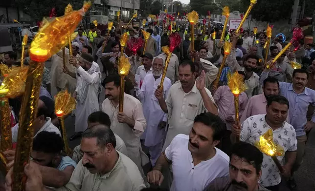 Pakistani workers take part in a rally a day ahead of the International Labor Day, in Karachi, Pakistan, Wednesday, April 30, 2025. (AP Photo/Fareed Khan)