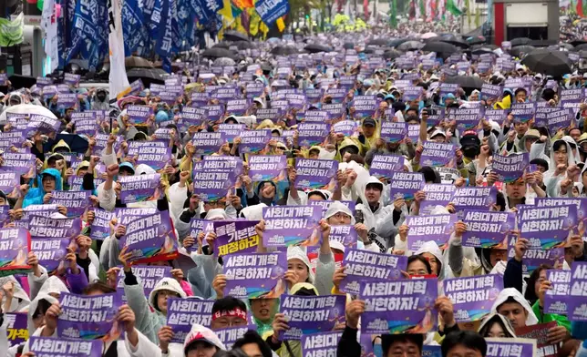 Members of the Korean Confederation of Trade Unions gather to attend a rally on May Day in Seoul, South Korea, Thursday, May 1, 2025. The letters read "Let's practice social reform." (AP Photo/Ahn Young-joon)