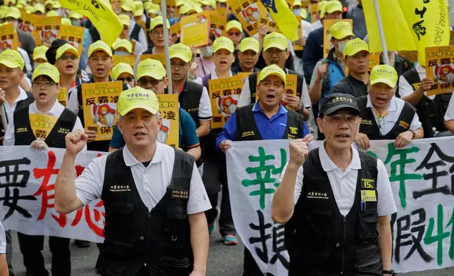 Taiwanese workers shout slogans during a May Day rally in Taipei, Taiwan, Thursday, May 1, 2025. (AP Photo/Chiang Ying-ying)