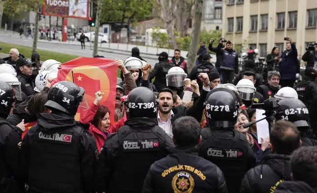 Union members are surrounded by Turkish police officers as they march during Labor Day celebrations in Istanbul, Turkey, Thursday, May 1, 2025. (AP Photo/Khalil Hamra)
