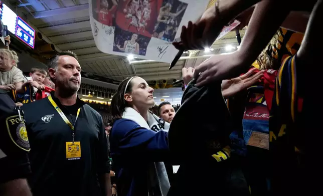 Indiana Fever guard Caitlin Clark signs autographs after an exhibition women's basketball game against Brazil, Sunday, May 4, 2025, in Iowa City, Iowa. (AP Photo/Charlie Neibergall)