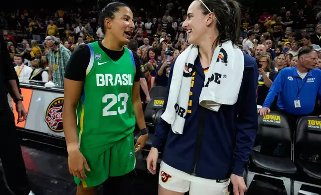 Brazil guard Izabela Leite (23) talks with Indiana Fever guard Caitlin Clark, center right, after an exhibition women's basketball game, Sunday, May 4, 2025, in Iowa City, Iowa. (AP Photo/Charlie Neibergall)