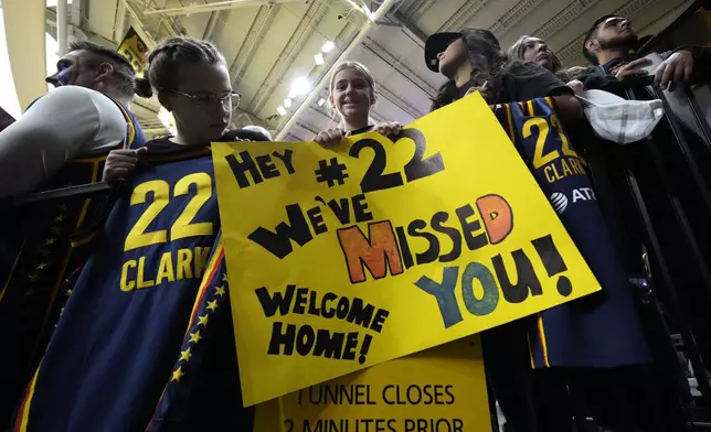 Fans watch Indiana Fever guard Caitlin Clark warm up before an exhibition women's basketball game against Brazil, Sunday, May 4, 2025, in Iowa City, Iowa. (AP Photo/Charlie Neibergall)