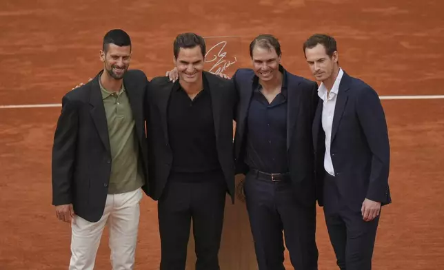 Rafa Nadal, second right, poses with, from left, Novak Djokovic, Roger Federer and Andy Murray, right, during a farewell ceremony at center court Philippe-Chatrier, at the Roland-Garros stadium, in Paris, Sunday May 25, 2025. (AP Photo/Thibault Camus)