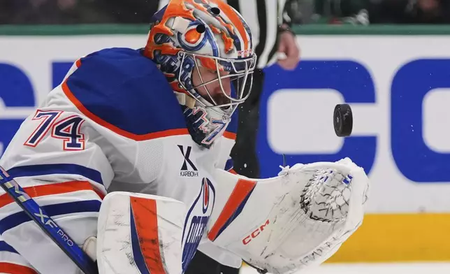 Edmonton Oilers goaltender Stuart Skinner stops a shot against the Dallas Stars during the first period of Game 5 of the Western Conference finals in the NHL hockey Stanley Cup playoffs, Thursday, May 29, 2025, in Dallas. (AP Photo/Julio Cortez)
