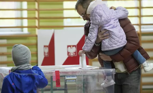 Voters cast their ballots polling stations opened in the first round of Poland's presidential elections in Warsaw, on Sunday, May 18, 2025. (AP Photo/Czarek Sokolowski)