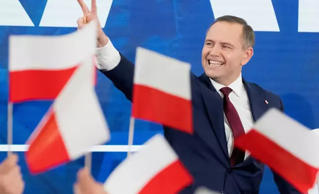 Karol Nawrocki, presidential candidate for the 2025 Polish presidential election supported by Poland's national conservative Law and Justice party, waves to supporters as first exit polls following presidential elections are announced in Gdansk, Poland, Sunday, May 18, 2025. (AP Photo/Wojciech Strozyk)