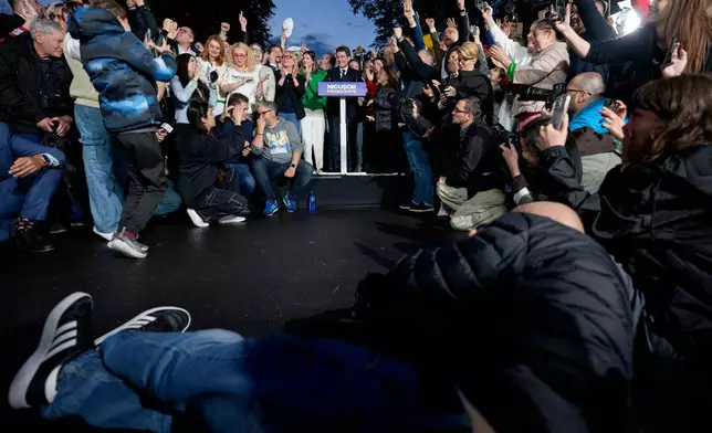 Presidential candidate Nicusor Dan, center, speaks to supporters after polls closed for the second round of the country's presidential election redo in Bucharest, Romania, Sunday, May 18, 2025. (AP Photo/Andreea Alexandru)