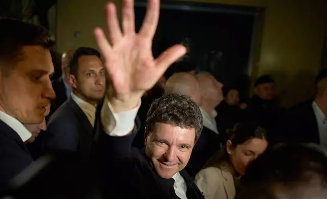 Presidential candidatee Nicusor Dan waves to supporters after winning the second round of the country's presidential election redo in Bucharest, Romania, early Monday, May 19, 2025. (AP Photo/Vadim Ghirda)