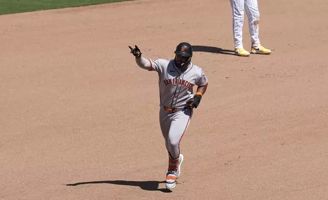 San Francisco Giants' Heliot Ramos rounds the bases after hitting a home run during the seventh inning of a baseball game against the San Diego Padres Wednesday, April 30, 2025, in San Diego. (AP Photo/Gregory Bull)
